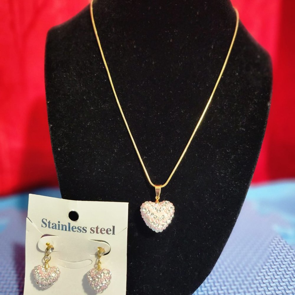 Beautiful and elegant heart necklace and earrings with pink rhinestones.
